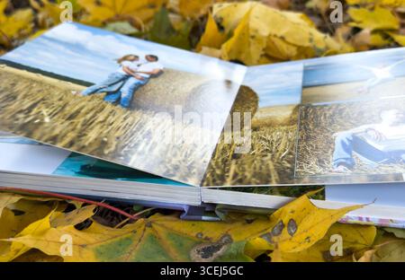 Photobook on the leaves background, closeup of photobook, family photo album. High quality photo Stock Photo