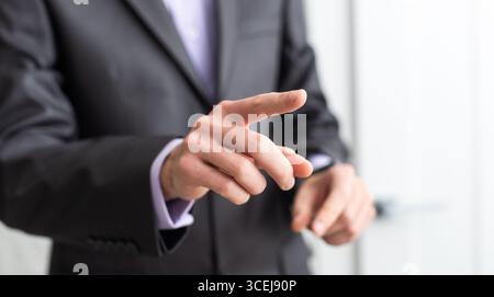 businessman touching an imaginary screen with clipping path isolated on white background. High quality photo Stock Photo