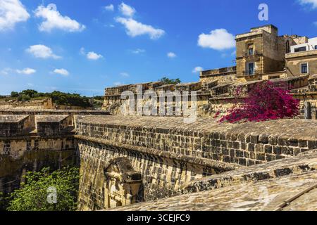 Part of the historic fortifications in Malta. Thick stone walls protect ...