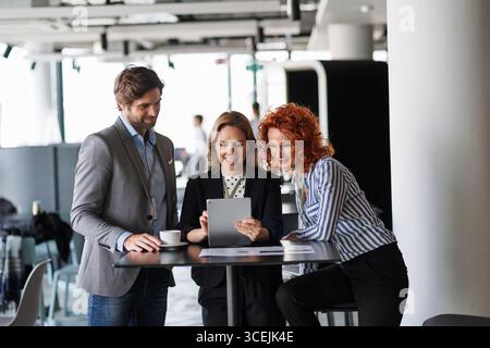 Creative team having discussion over coffee about project strategy. Stock Photo