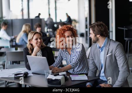 Creative team having discussion over coffee about project strategy. Stock Photo