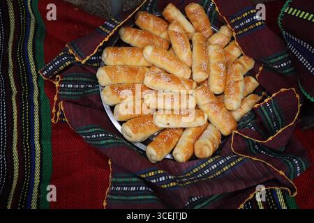 Freshly baked homemade bread arranged in traditional Bulgarian textiles. Image of some tasty Home-made bakery products. Stock Photo