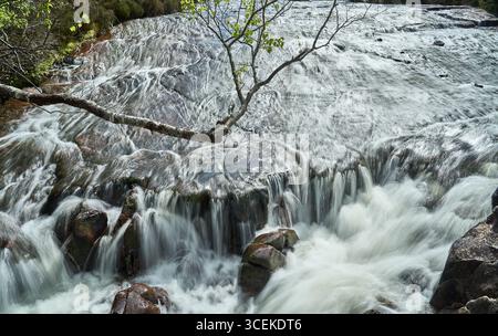 flowing water of the Victoria Falls at Loch Maree in the highlands of Scotland Stock Photo