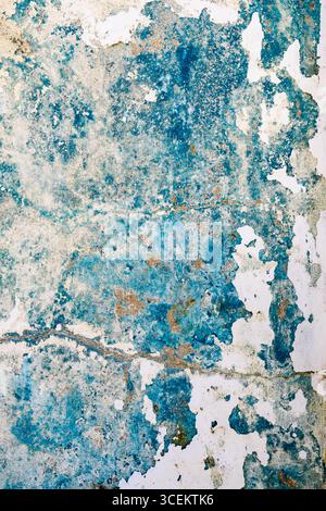 Stained and worn concrete with fading blue paint Stock Photo