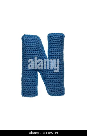 A large letter N, handmade from blue knitted yarn. Stock Photo