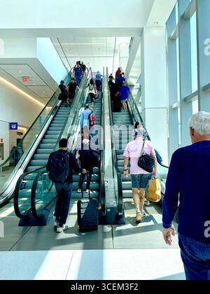 Escalator at Laguardia Airport, New York, 2025, going up with many people. Stock Photo