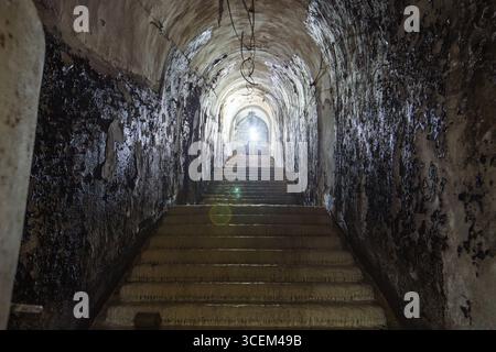 Old vaulted corridor of Soviet bunker, echo of Cold War. Stock Photo
