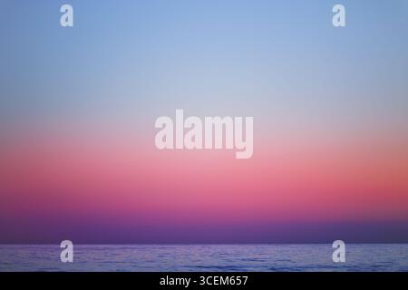 Beautiful evening landscape with sunset over the sea water surface. Stock Photo