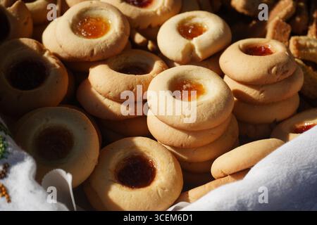Authentic Cretan 'koulouraki' butter cookies with apricot and strawberry jam. Traditional Greek pastry, a delicious holiday or coffee-time treat. Stock Photo