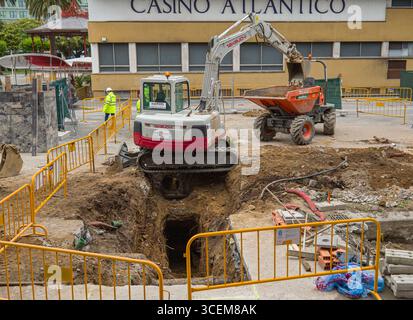 Excavator digging a trench ditch for a small house foundation Stock ...