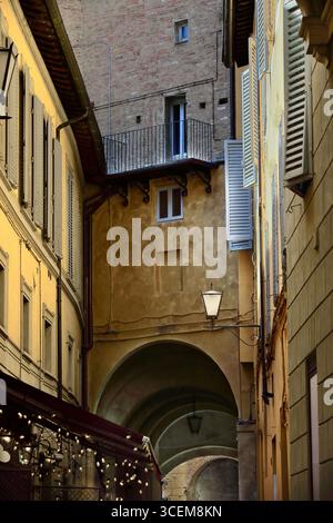 206 Via Beccheria Street's tunneled passage under several buildings at the end of the way, just before flowing into Via Diacceto Street. Siena-Tuscany Stock Photo
