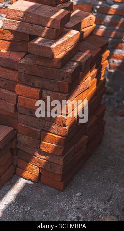 The texture of red bricks creates a classic and aesthetic look, serving as a strong and durable architectural element in construction. Stock Photo