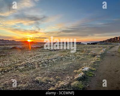 Glimpse of mist from Dettifoss waterfall in the background during golden hour. Stock Photo