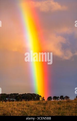 Rainbow over the countryside at Blayney in the Central West of NSW, Australia. Stock Photo