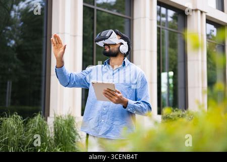 Man Using VR Headset Outdoors Stock Photo