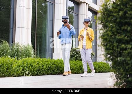 People Using VR Headsets Outdoors Stock Photo