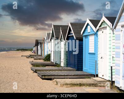 Row of beach huts on the sandy beach at West Mersea, Mersea Island, Essex, East Anglia. Stock Photo