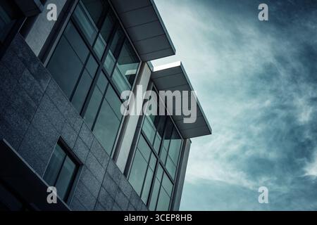 Architectural abstract, dark and moody blue tones, with sky background and space for text. Stock Photo