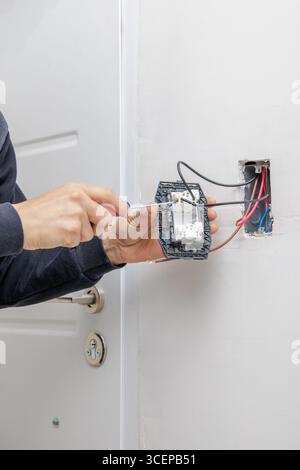 Hands of an electrician working on an electrical installation. Stock Photo