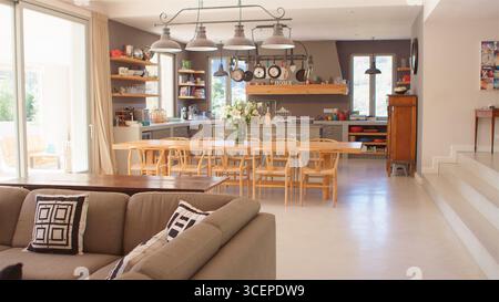 Interior Of Kitchen, Dining Area And Lounge Of Modern Open Plan Home Stock Photo