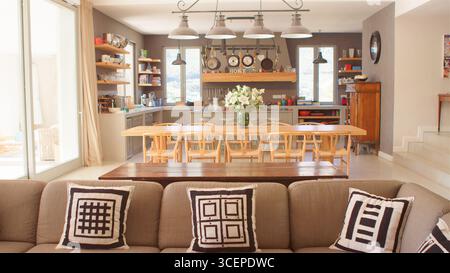 Interior Of Kitchen, Dining Area And Lounge Of Modern Open Plan Home Stock Photo