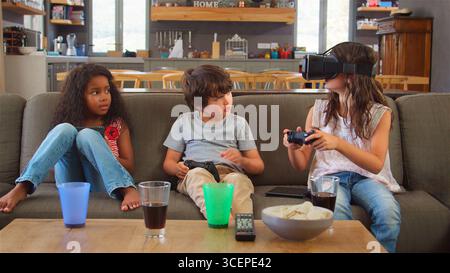 Children Play Computer Game Using Virtual Reality Headset Stock Photo