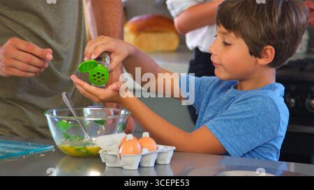 Close Up Of Father And Son In Kitchen At Home Making Morning Breakfast Together Stock Photo