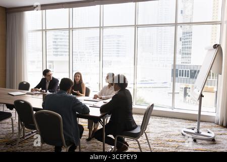 Diverse stakeholders group hold negotiations in round table format Stock Photo