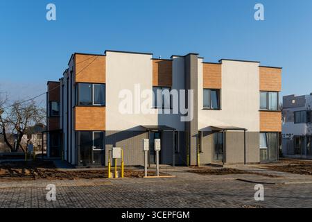 Two-story townhouse at final construction stage. Landscaping the adjacent area. Stock Photo