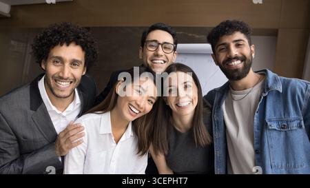 Group portrait diverse multiracial group five smiling friendly young people Stock Photo