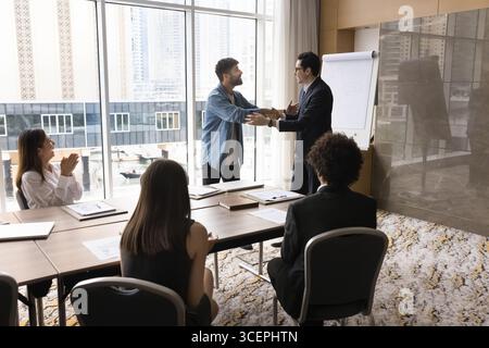 Thankful top executive handshaking smiling business coach appreciate for workshop Stock Photo