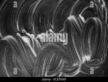 Abstract white soap curved lines on black background. Stock Photo