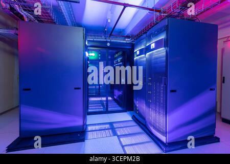 Modern Server Room Data Center with Rows of Server Racks, High-Tech IT Infrastructure, Network Equipment and Advanced Digital Technology Stock Photo