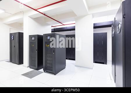 Modern Server Room Data Center with Rows of Server Racks, High-Tech IT Infrastructure, Network Equipment and Advanced Digital Technology Stock Photo