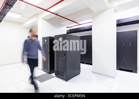 Modern Server Room Data Center with Rows of Server Racks, High-Tech IT Infrastructure, Network Equipment and Advanced Digital Technology Stock Photo