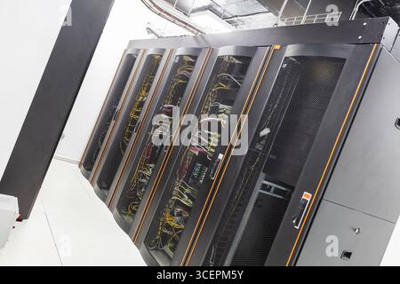 Modern Server Room Data Center with Rows of Server Racks, High-Tech IT Infrastructure, Network Equipment and Advanced Digital Technology Stock Photo