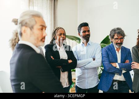 Multiracial business people working inside corporate office - Financial strategy meeting concept - Main focus on senior african woman face Stock Photo