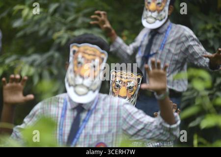 Agartala, Tripura, India, 29-07-2025: Students of NSS (National Service Scheme) unit from Mahatma Gandhi Memorial School wearing tiger masks during an Stock Photo