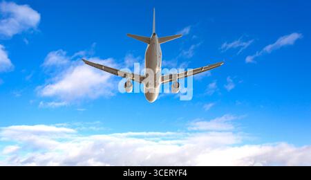 White passenger airplane flying high above white clouds on beautiful sunny day with deep blue sky Stock Photo