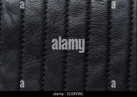 Black leather surface with stitches macro close up view Stock Photo