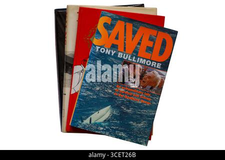 Selection of hardback books with Saved book by Tony Bullimore on top isolated on white background Stock Photo