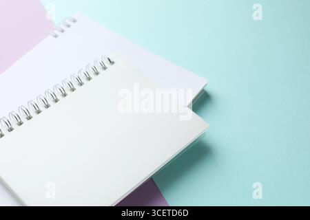 White notebooks on color background, closeup. Space for text Stock Photo