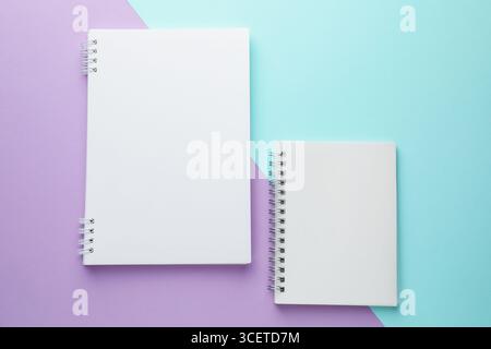 White notebooks on color background, flat lay Stock Photo