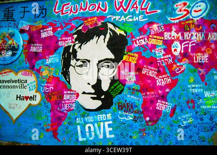 Colorful mural artwork on the Lennon Wall in Prague, Czech Republic, featuring a portrait of John Lennon and the phrase “All You Need Is Love” Stock Photo