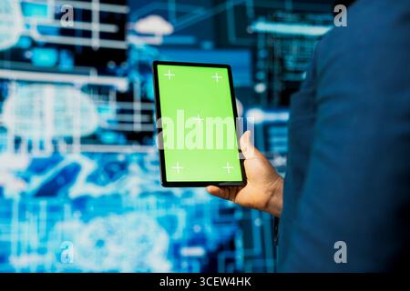 Black IT engineer analyzing algorithmic data next to copy space, uses devices surrounded by futuristic digital visuals. AI smart technology and neural networks in a high tech environment. Stock Photo