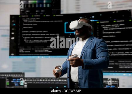 Black professional engineer engaging in virtual reality with glasses, focusing on system development. Utilizing code on terminal window to debug and design new software. IT career. Stock Photo