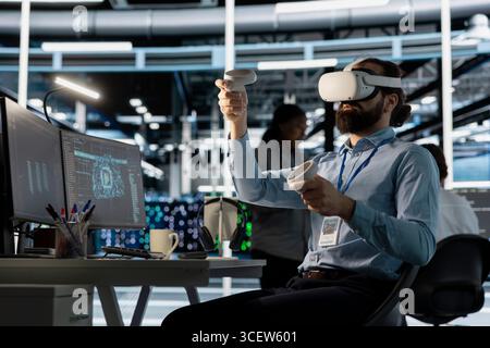 Data center worker wearing VR headset using artificial intelligence neural networks technology. Server farm software developer using AI programming language and virtual reality to update hardware Stock Photo