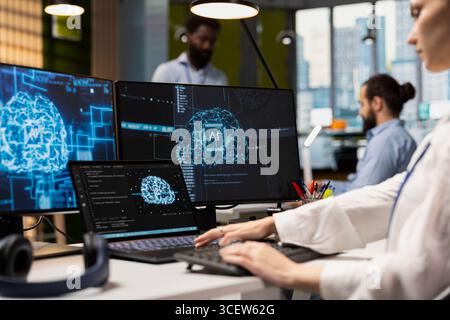 Admin using devices to adjust neural networks algorithms parameters, automating workflow. Tech company worker using artificial intelligence insights for code optimization in office Stock Photo