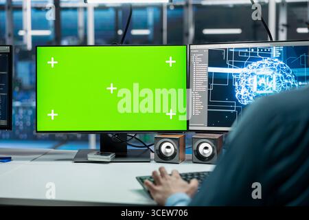 Close up of server room IT specialist using isolated screen PC, deploying deep learning technology. Data center engineer using mockup computer, managing datasets used in neural networks training Stock Photo