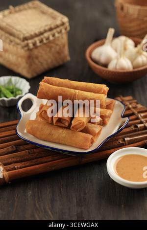 Chinese Egg Rolls, Deep Fried Chives Spring Rolls or Gui Chai on a Ceramic Plate. Gorengan Lumpia Stock Photo